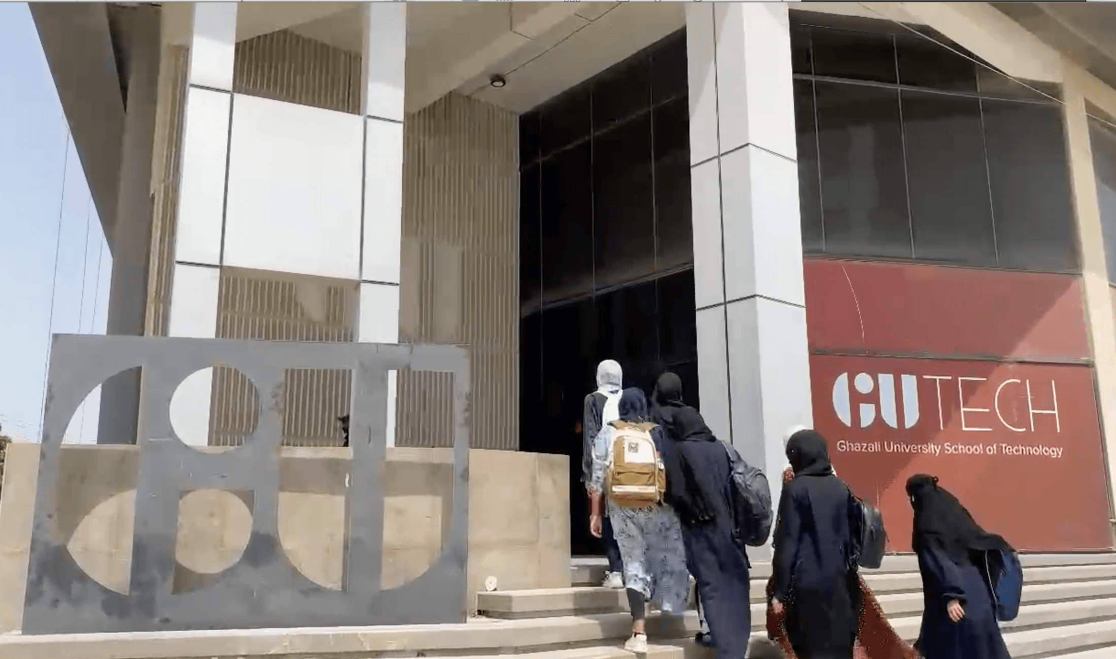 Students entering GU TECH campus building